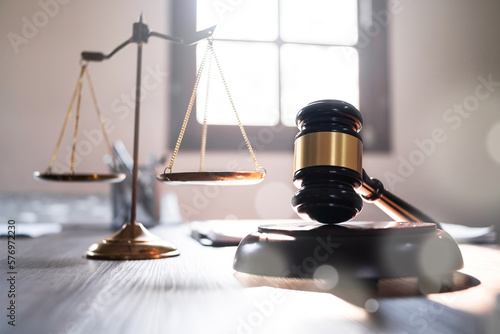 Judge hammer and scale balance on judge work desk.