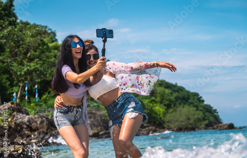 Summer life portrait of sexy woman enjoying with friends selfie and laugh out loud on tropical island.
