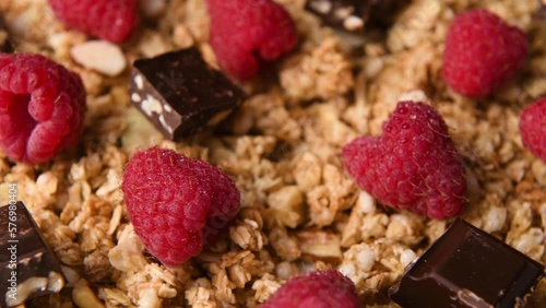 Detail close up shot of granola with chocolate and raspberries. photo