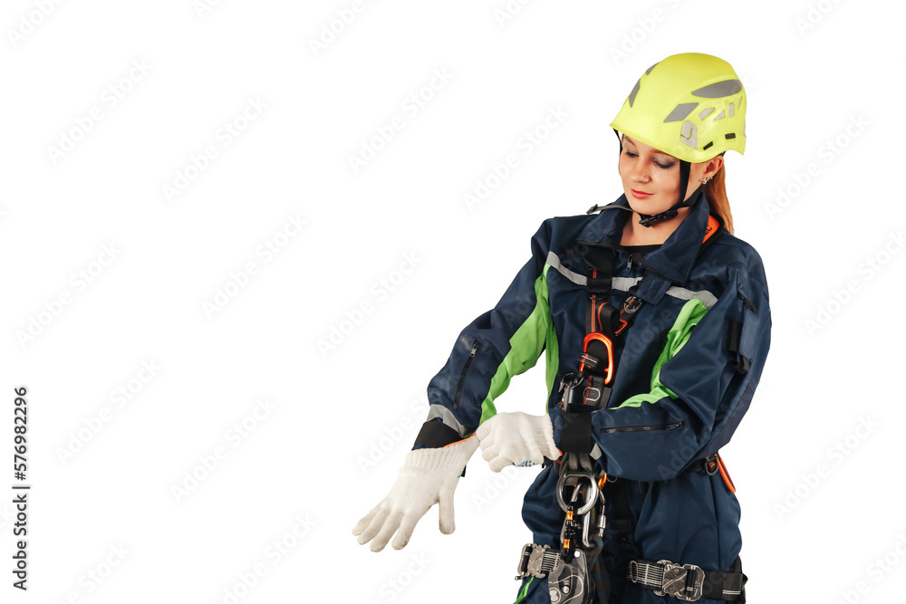 Industrial lady in industry uniform and protective helmet puts gloves at isolated white empty background. Serious confident woman worker in workwear standing in isolation. Copy advertising text space