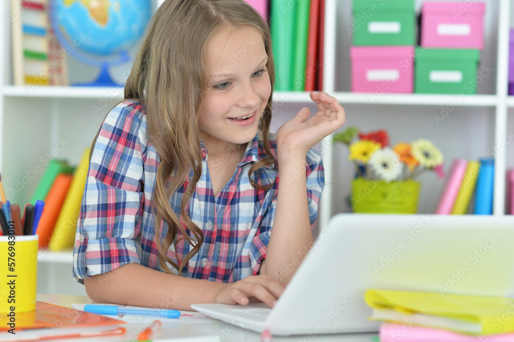 girl using laptop at desk at home girl using laptop at desk at home