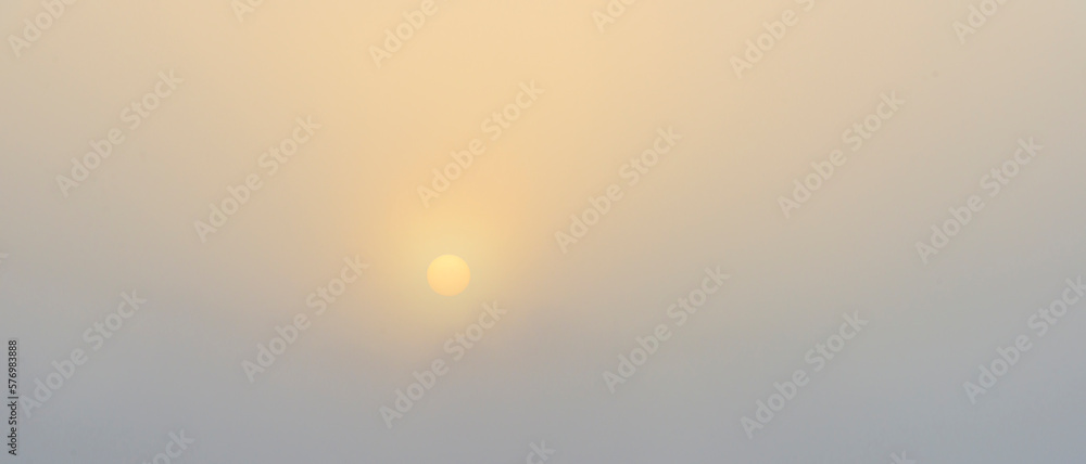 Rising sun in a foggy sky in sunlight at sunrise in winter, Almere, Flevoland, The Netherlands, March 1, 2023