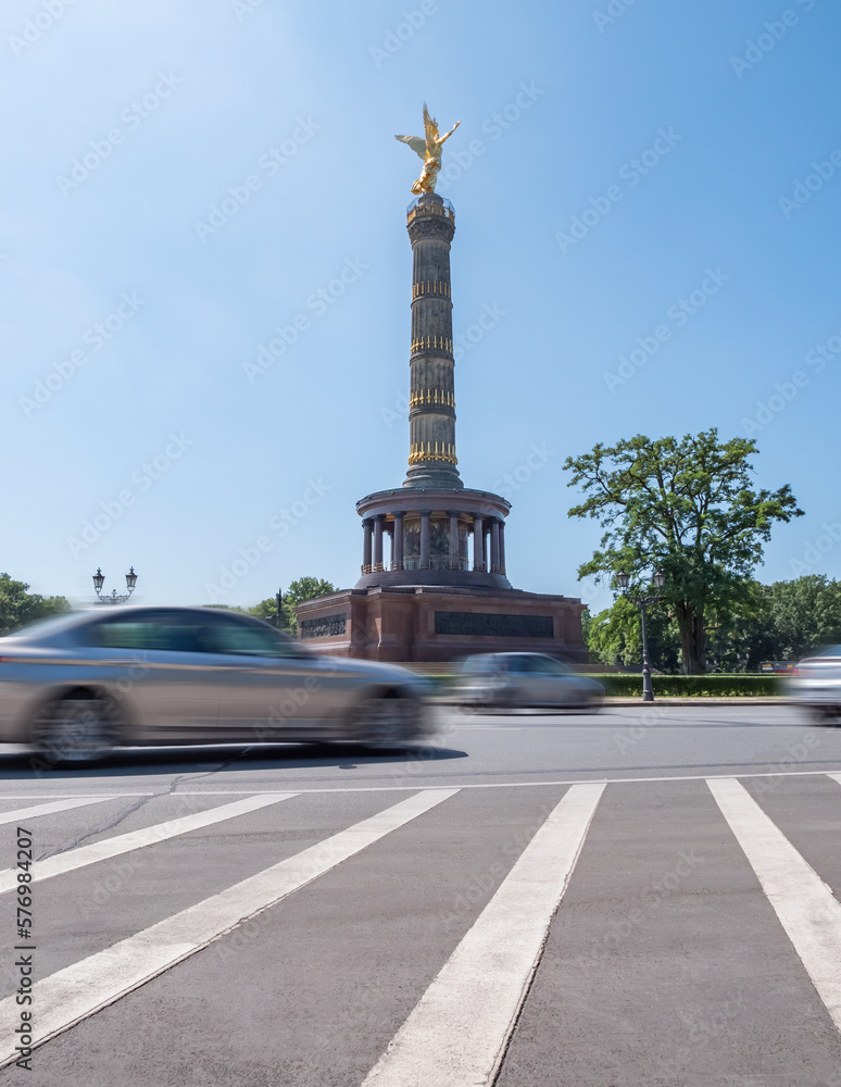 Victory column, Berlin, Germany during summer with clear sky, traffic in front, no people, long exposure, view from low angle