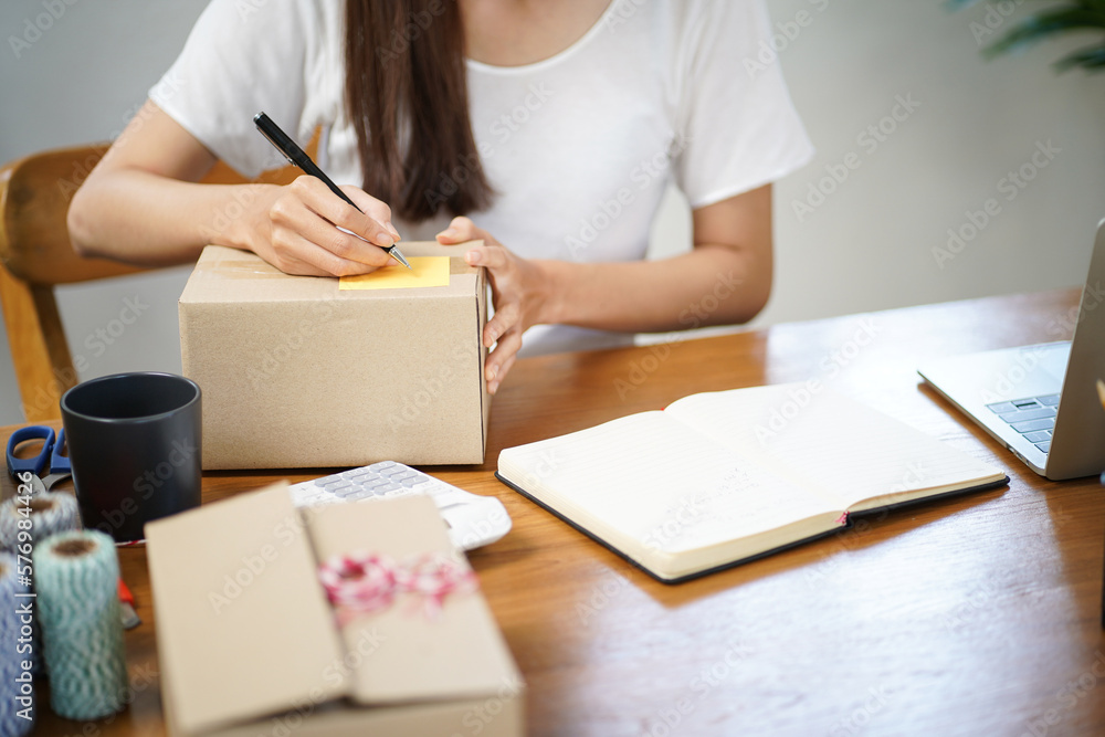 Business From Home Asian woman preparing package delivery box Shipping for shopping online. young start up small business owner at home online order Business From Home Asian woman preparing package delivery box Shipping for shopping online. young start up small business owner at home online order