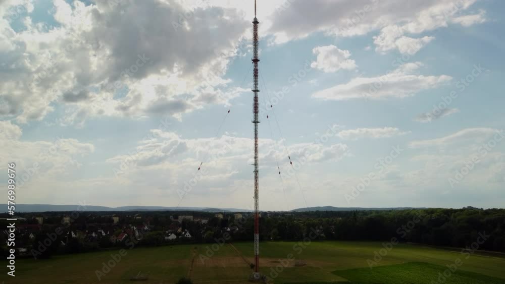 Climbing an antenna in front of a village Climbing an antenna in front of a village