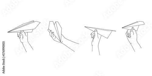Hand holding a paper airplane. International Civil Aviation Day. Isolated on white background