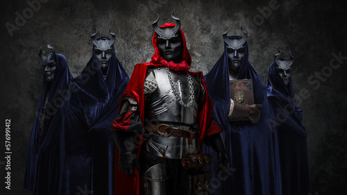 Studio shot of esoteric brotherhood of five people with robes and horned masks.