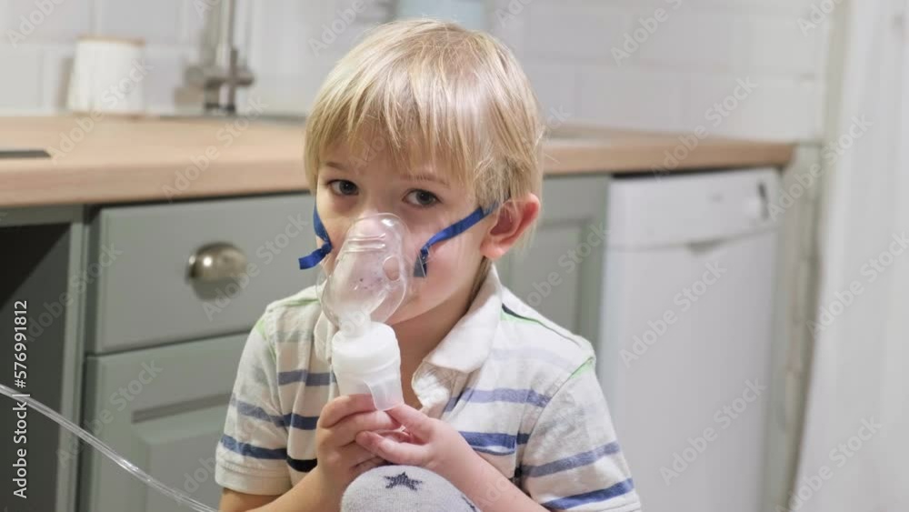 Sick Baby Boy with making Inhalation with a Mask on his Face sitting in