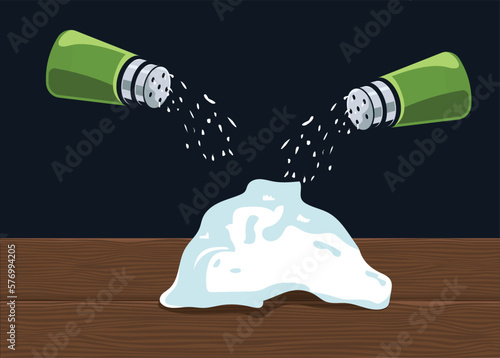 heap of salt sprinkled on wooden table from a salt bottle. Salt falling from container adds motion feel to the kitchen wear item and can be used in posters or graphics related to food and salty dishes