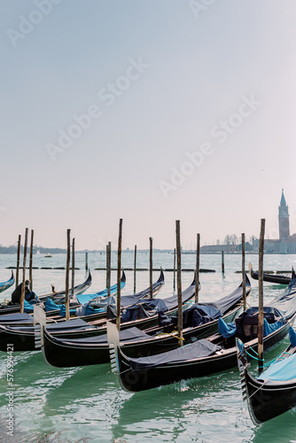 Countless gondolas are docked in the port of Venice. Waiting for the next passenger to travel to new adventures.