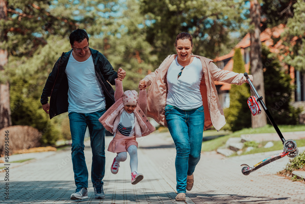 Obraz premium Family fun in the park. Happy family spending time in park and playing with their daughter