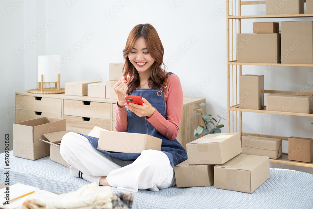 Young Asian Business women are happy and excited after a new order from SME customer, commercial checking, online marketing, Entrepreneur packing boxes, SME sellers, Freelance online sales concept,. Young Asian Business women are happy and excited after a new order from SME customer, commercial checking, online marketing, Entrepreneur packing boxes, SME sellers, Freelance online sales concept,.