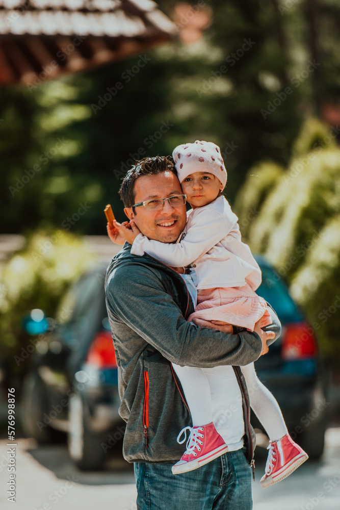 Fototapeta premium Family time in the park. Father have fun with his daughter in the park, playing fun games and spending time together