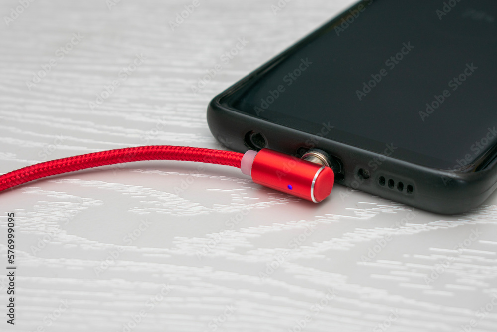 Magnetic cable for charging smartphone, close up. Magnetic cable for charging smartphone, close up.