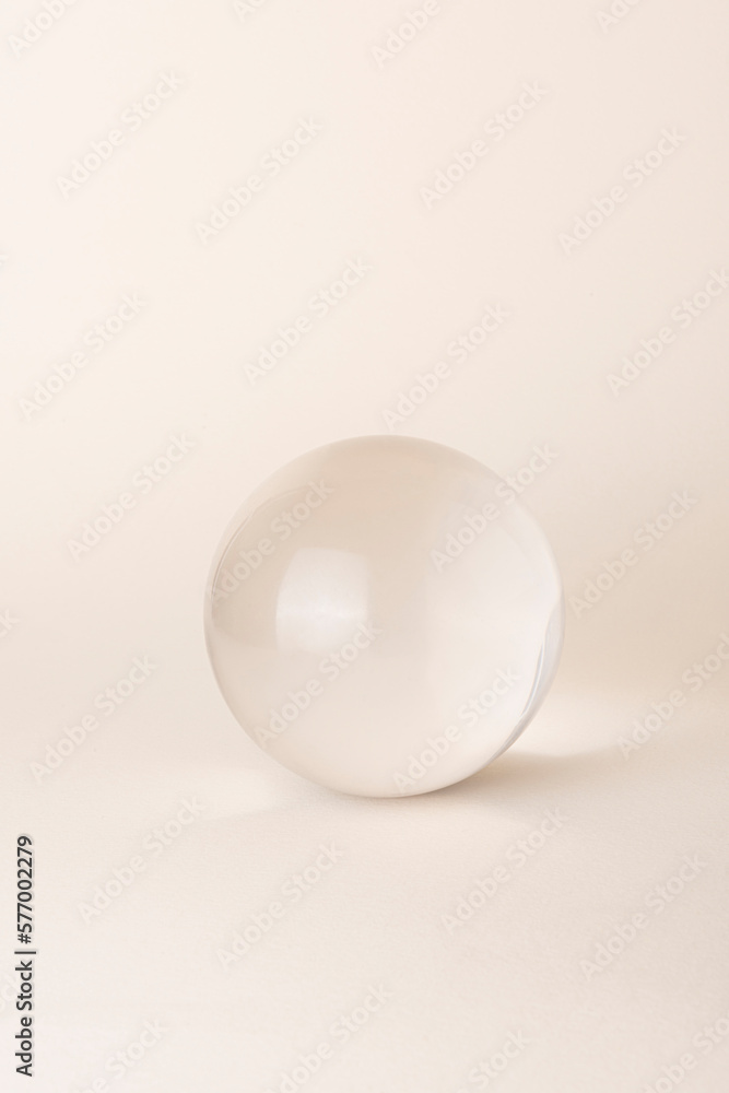 glass sphere on beige background glass sphere on beige background