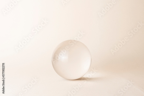 glass sphere on beige background photo