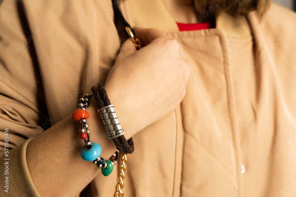 Close-up of handmade unisex leather bracelets with silver beads and coloured stones.