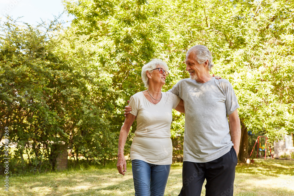 Happy retired couple walking in the park