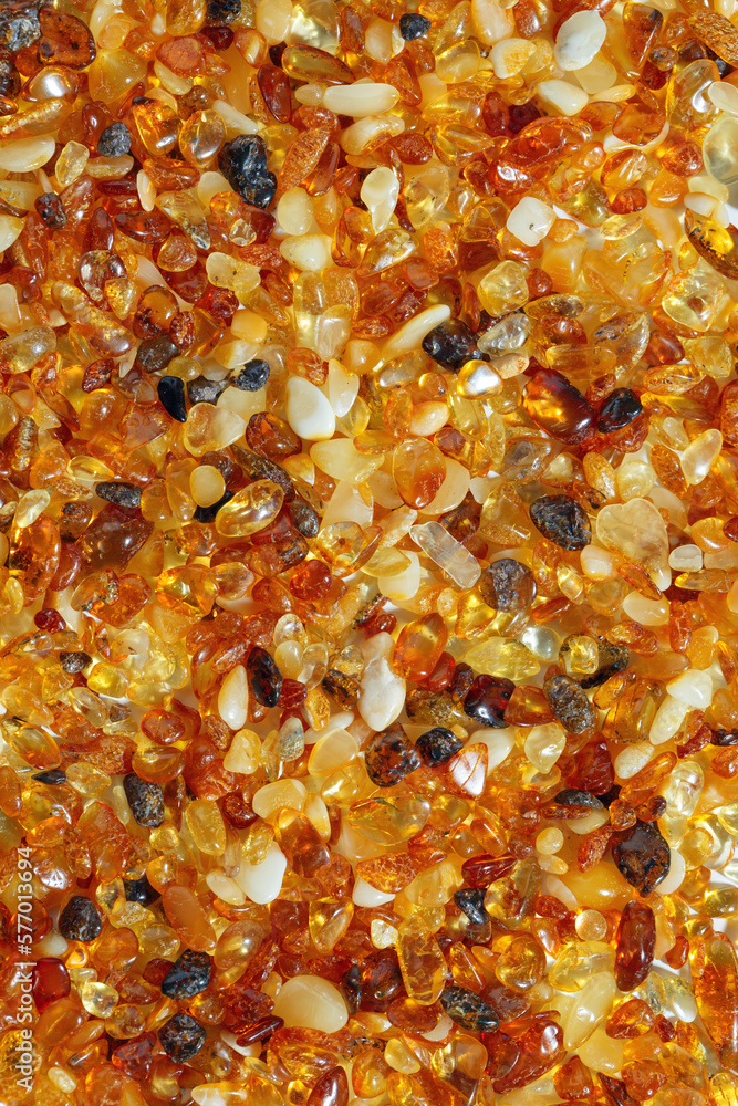 Natural gemstone amber texture background, small stones yellow orange gradient color. Natural mineral material for jewelry. Top view Amber texture. Aesthetic sunstones wallpaper, pieces ancient resin. Natural gemstone amber texture background, small stones yellow orange gradient color. Natural mineral material for jewelry. Top view Amber texture. Aesthetic sunstones wallpaper, pieces ancient resin.
