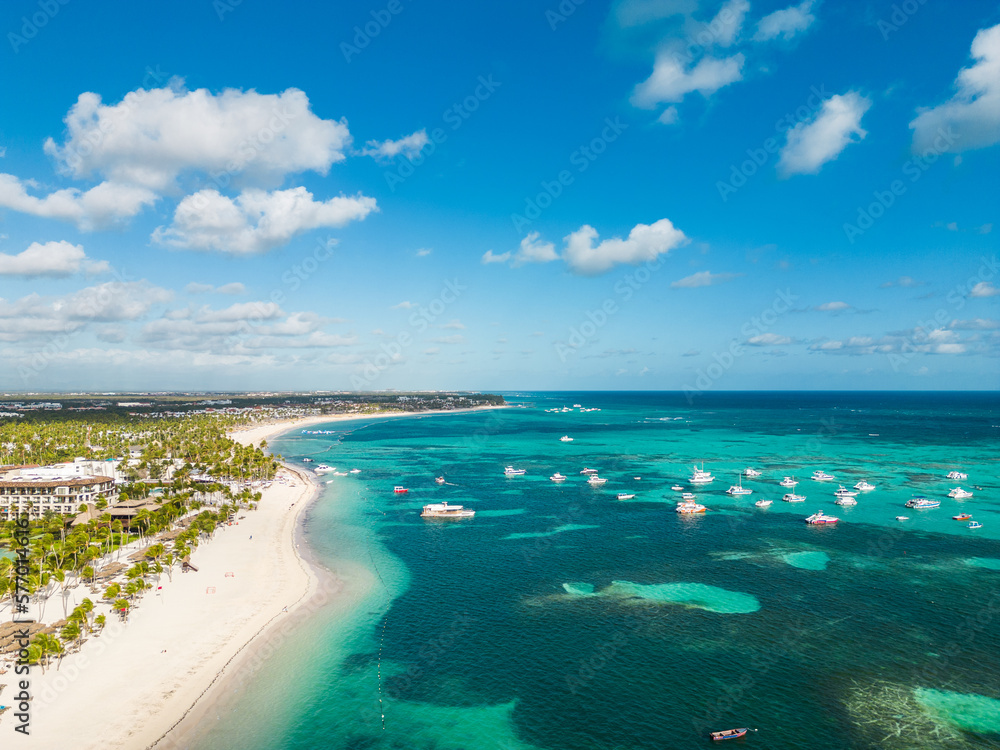 Fototapeta premium Aerial view of the large tropical beach with white sand and turquoise water of the Caribbean Sea. Best All Inclusive Hotels in Punta Cana