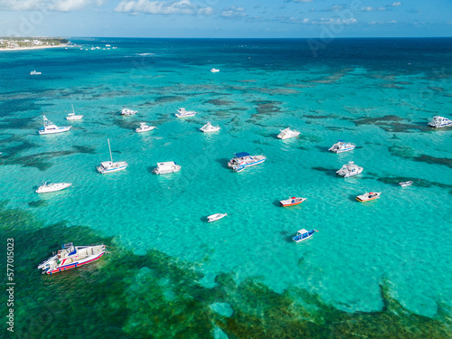 Many anchoring yachts and tourist boats in the turquoise Caribbean sea. Bavaro beach, Punta Cana