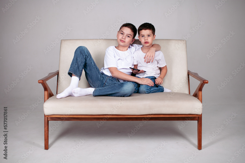 two brothers sitting in white t-shrt two brothers sitting in white t-shrt