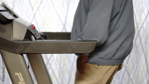 walking on treadmill working black male man in a hood