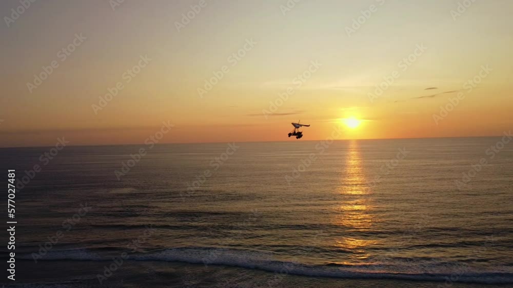 Amazing Aerial View Of Sunset On The Beach And A Motorized Paraglider Amazing Aerial View Of Sunset On The Beach And A Motorized Paraglider