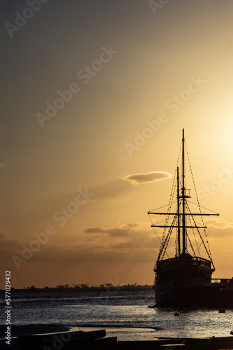Sunset at the pier. Boats and motorboats docked at the pier. Pirate Ship.

