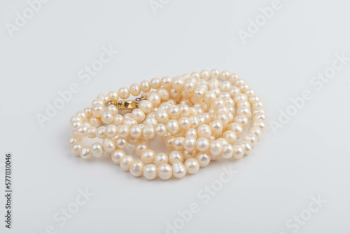 Pearls on white background. Feminine necklace jewelry.