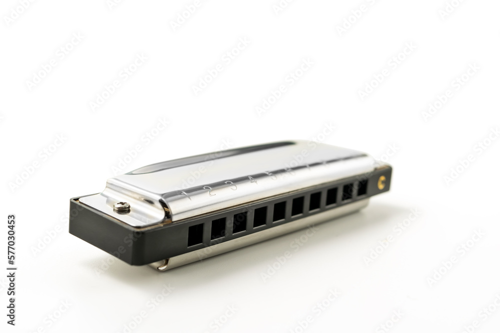 Harmonica, also French harp, blues harp, and mouth organ, isolated on white background with clipping path included. Free reed wind instrument used worldwide in blues, American folk, jazz, rock and rol Harmonica, also French harp, blues harp, and mouth organ, isolated on white background with clipping path included. Free reed wind instrument used worldwide in blues, American folk, jazz, rock and rol