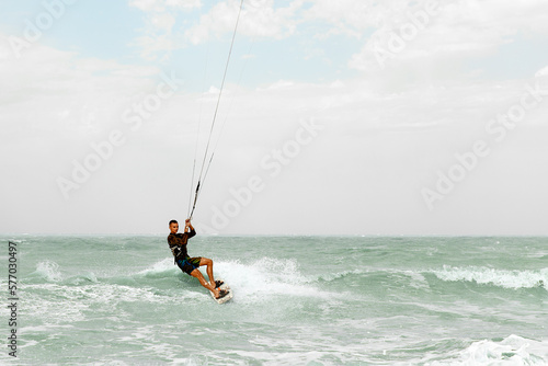 Kite surfing, kite surfing man preparing to make a jump, cutting ocean waves, kite surfing on vacation