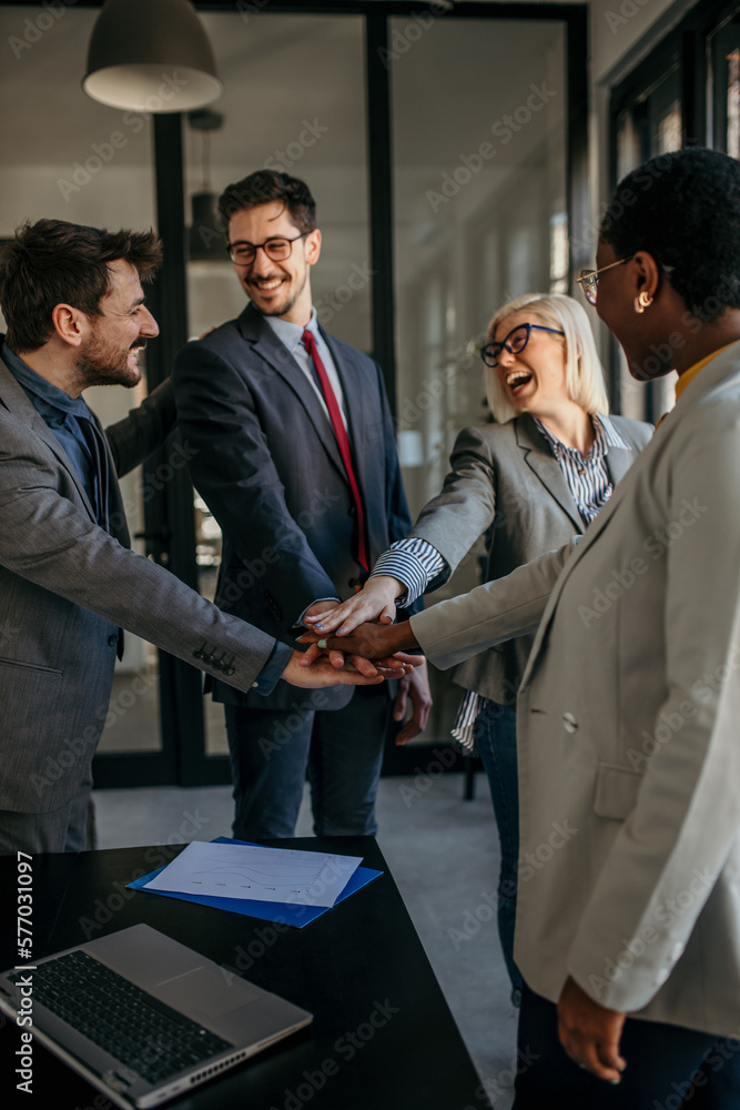 Happy diverse colleagues working united as a team. Business teamwork results are motivated by business success victory loyalty unity concept, good corporate relations, and team building. Happy diverse colleagues working united as a team. Business teamwork results are motivated by business success victory loyalty unity concept, good corporate relations, and team building.