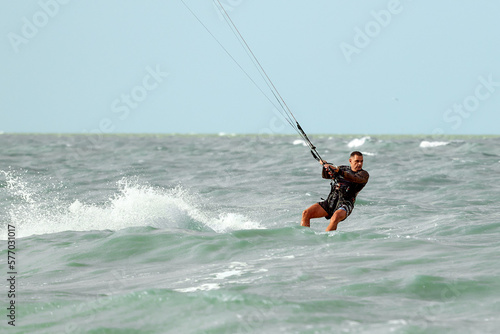 Kite surfing, kite surfing man preparing to make a jump, cutting ocean waves, kite surfing on vacation