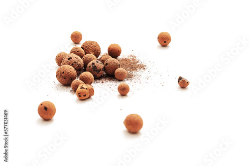 Expanded clay pebbles used as a growing media in hydroponics with sun light on white background