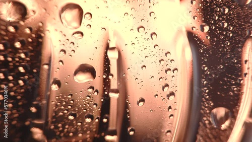 macro level view of water sweat water beads in bottle bright light