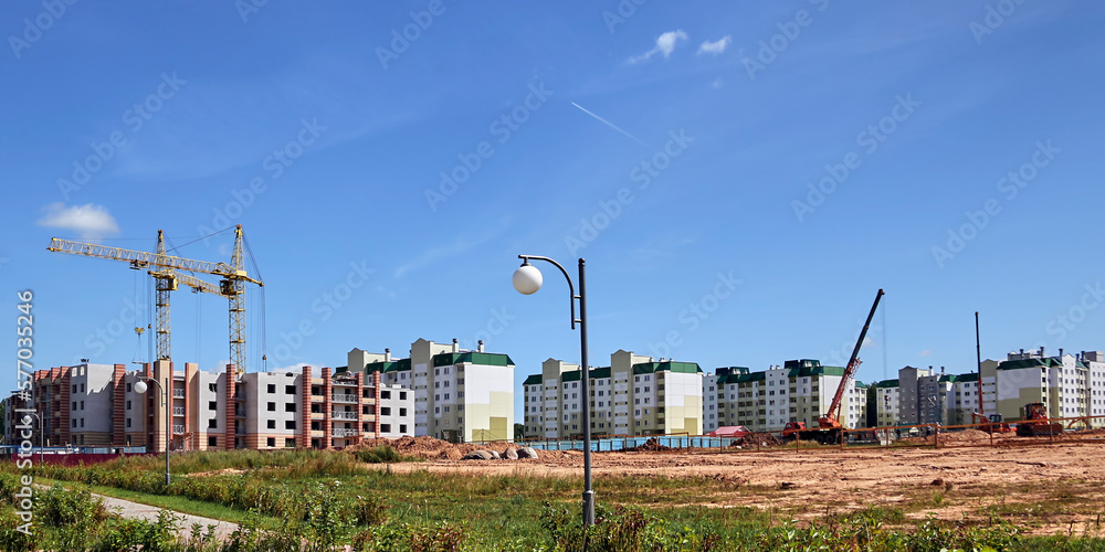 Panoramic view of construction sites and many cranes working