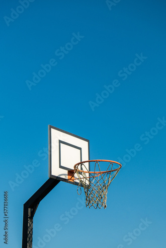 Street basketball hoop on background of vibrant sky. Creative minimalistic photo. Street Basketball Loop Basket Outdoors Abstract sport wide blank empty background texture, copy space. Sports, leisure © anna.stasiia