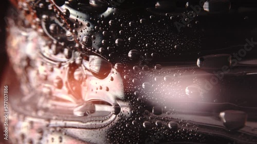 macro level view of water sweat water beads in bottle bright light