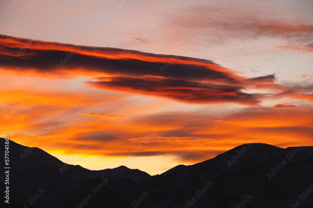 Majestic mountain landscape with a silhouette of a mountain range at sunset. Colorful sunset over mountain hills