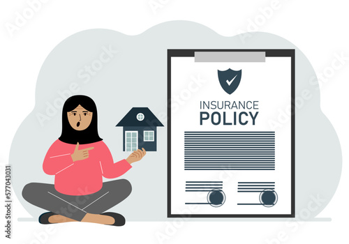 A woman holds in his hands at home next to a large insurance contract. Home and real estate insurance concept.