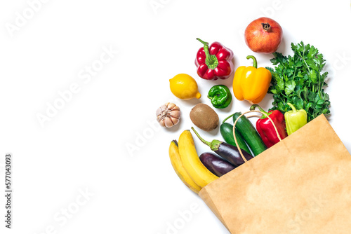 Eco friendly paper shop bag with raw organic green vegetables isolated on white background Flat lay, top view Zero waste, plastic free concept Healthy clean eating diet and detox, agriculture concept