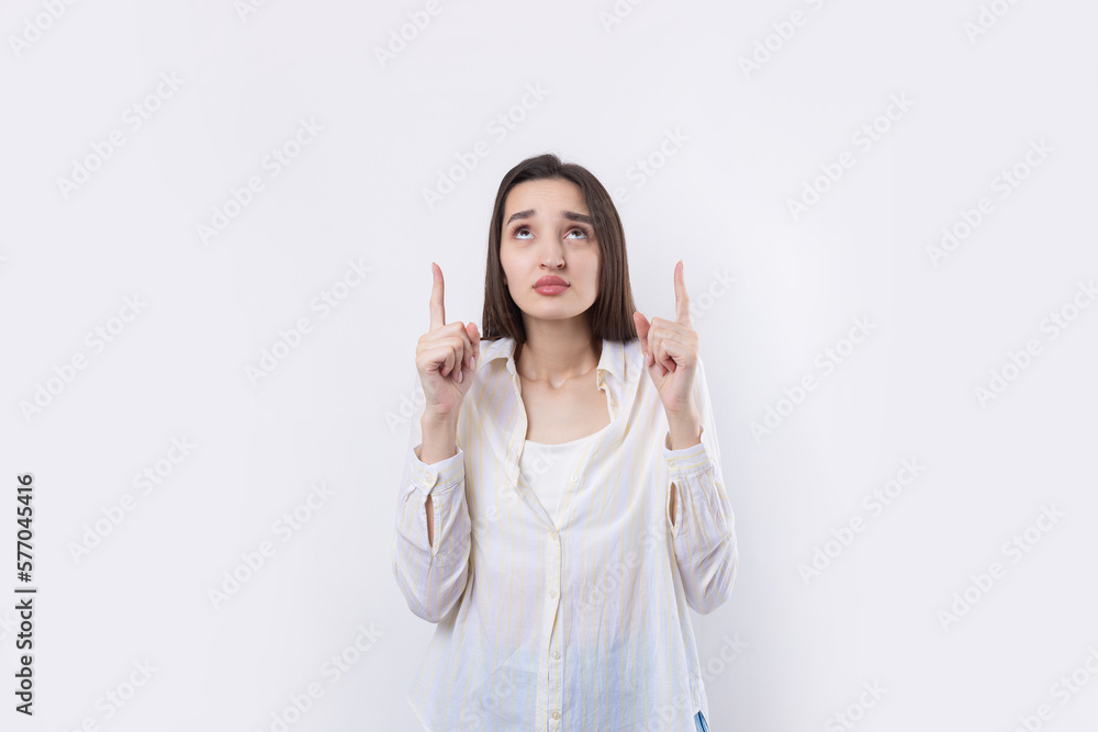 Happy young caucasian female in a shirt pointing fingers away Happy young caucasian female in a shirt pointing fingers away