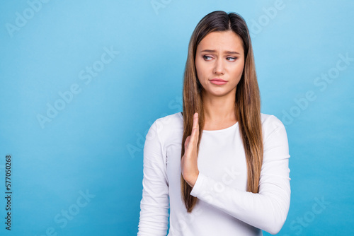 Photo of serious unsure lady dressed white shirt showing stop gesture empty space isolated blue color background