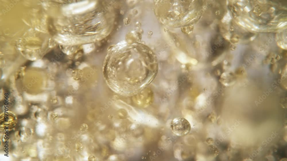 Super Slow Motion Shot of Oil Bubbles on Golden Background at 1000fps. Shoot on high speed cinema camera. Super Slow Motion Shot of Oil Bubbles on Golden Background at 1000fps. Shoot on high speed cinema camera.