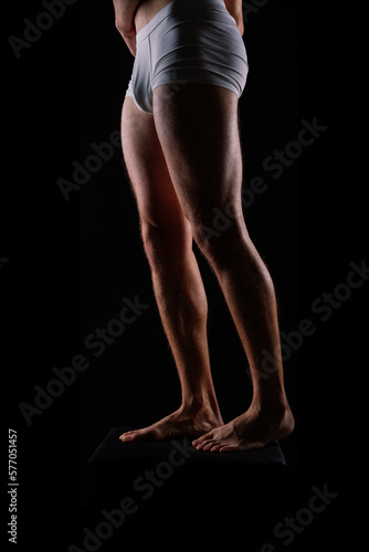 Close-Up of Bodybuilders Legs Ready For Competitive Sport white panties © Ivan Zelenin