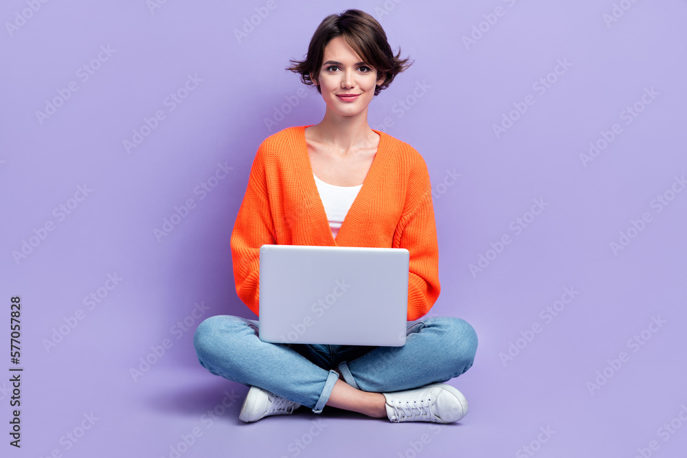 Naklejka premium Full body length cadre of confident programmer professional python coder young woman use hp netbook performance isolated on violet color background