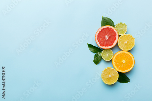 Fruit background. Colorful fresh fruits on colored table. Orange  lemon  grapefruit Space for text healthy concept. Flat lay  top view  copy space
