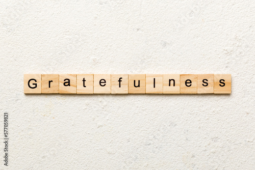 gratefulness word written on wood block. gratefulness text on cement table for your desing, concept photo