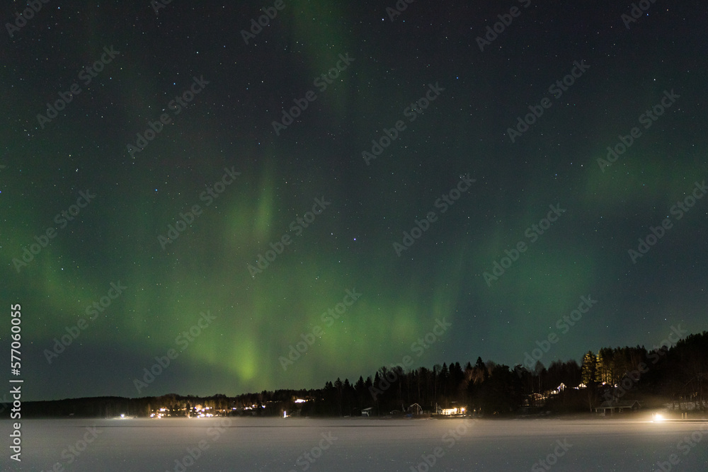 Sweden by night. aurora borealis captured over a frozen lake.